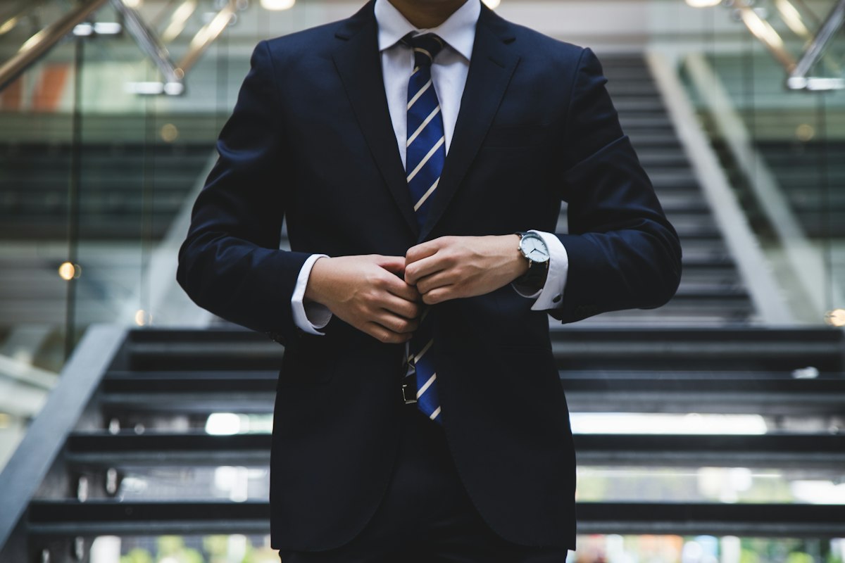 Businessman in a suit adjusting his jacket