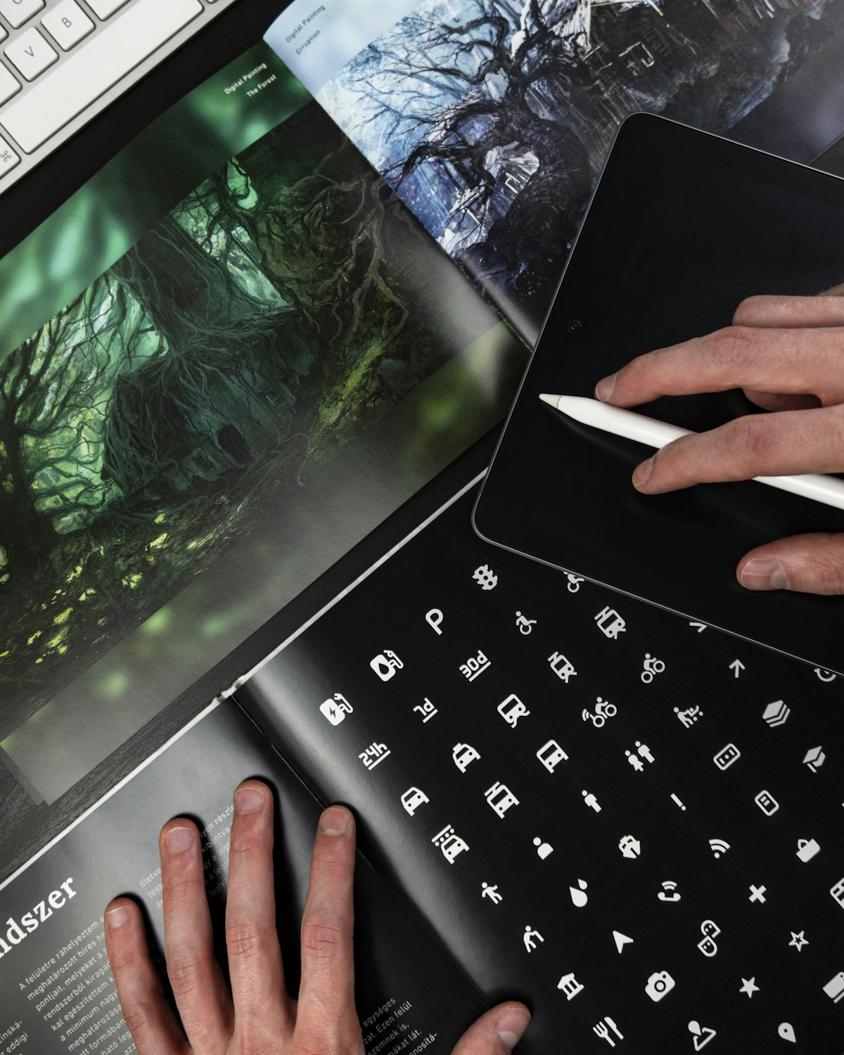 Design workspace with tablet, stylus and icon sheets